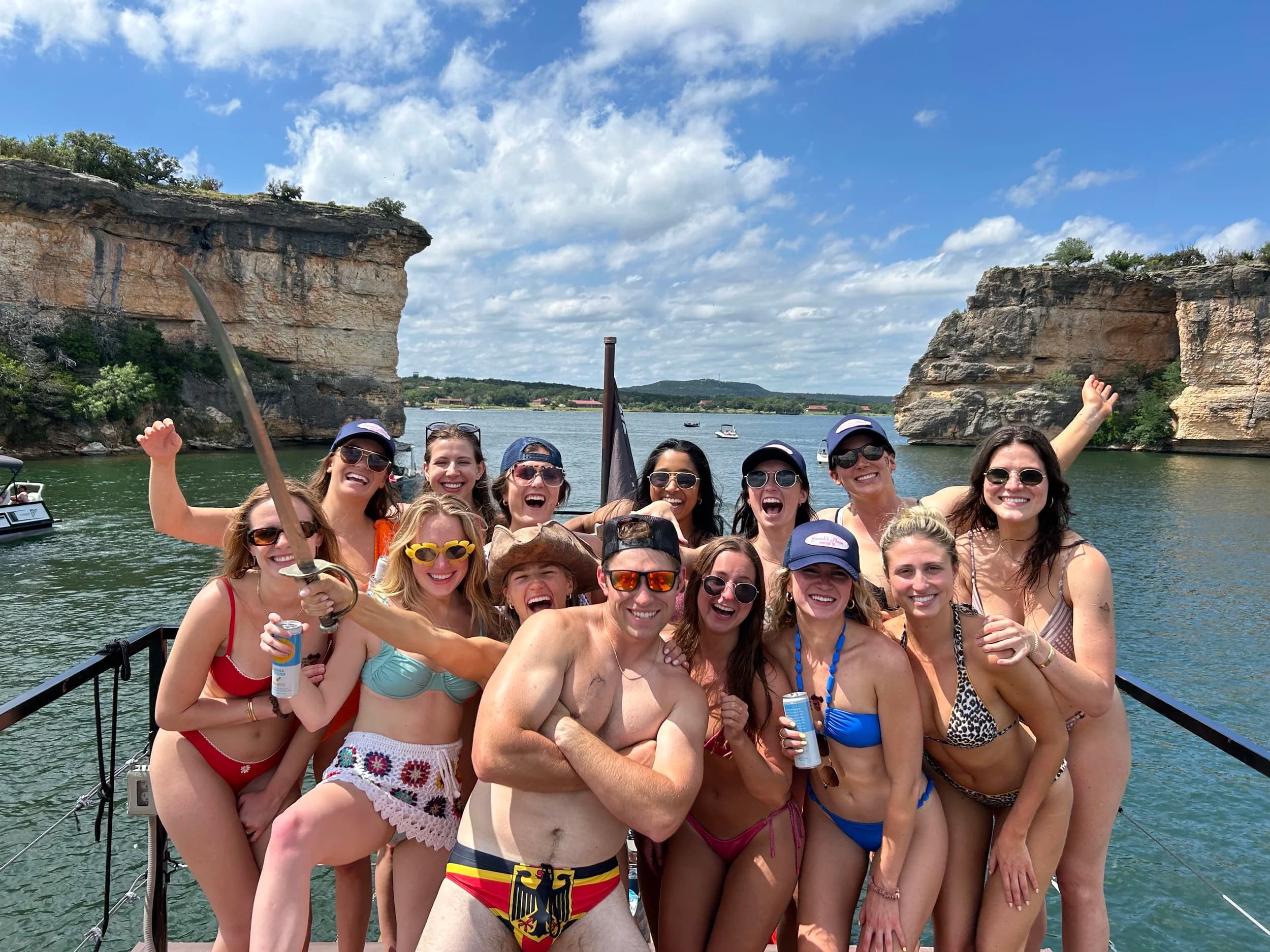 Group celebrating on the pirate ship with limestone cliffs